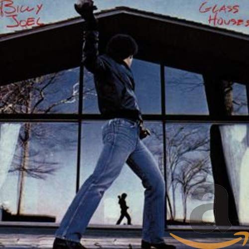 Billy Joel’s “Glass Houses” album cover: man silhouetted before a house.