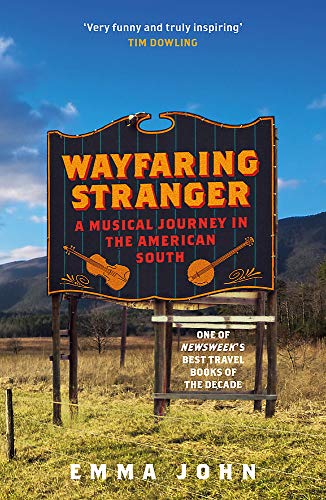 Book cover showing a road sign with title and musical instruments in a field.