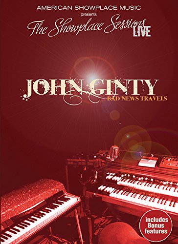 Sealed DVD case with keyboards on stage, red lighting, and text "John Ginty - Bad News Travels".