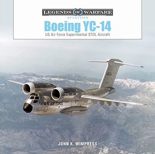 Boeing YC-14 aircraft in flight over a mountainous landscape.