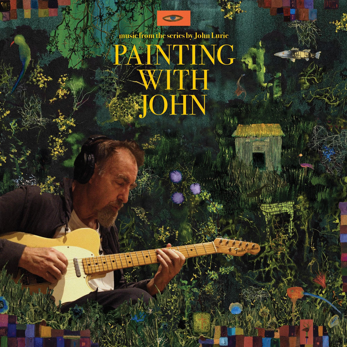John Lurie wearing headphones and playing an electric guitar against a dark, painted background.
