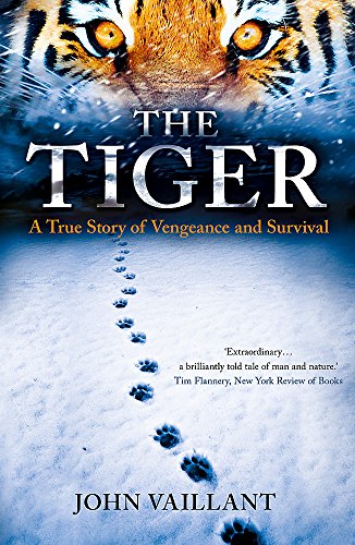 Book cover featuring a tiger’s face and paw prints in snow.
