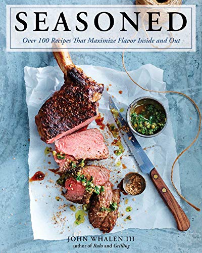 Cookbook cover featuring a sliced, seasoned ribeye steak with herbs and spices.
