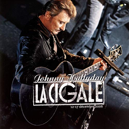Vinyl record album cover with man playing guitar and two white vinyl discs.