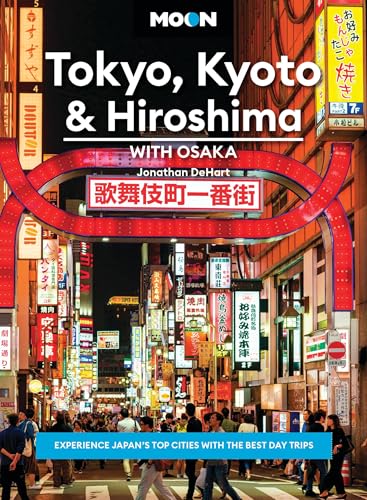 Travel guidebook cover featuring a brightly lit Japanese city street at night.