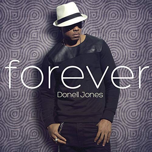 Man in white hat and black clothing on album cover with geometric background.