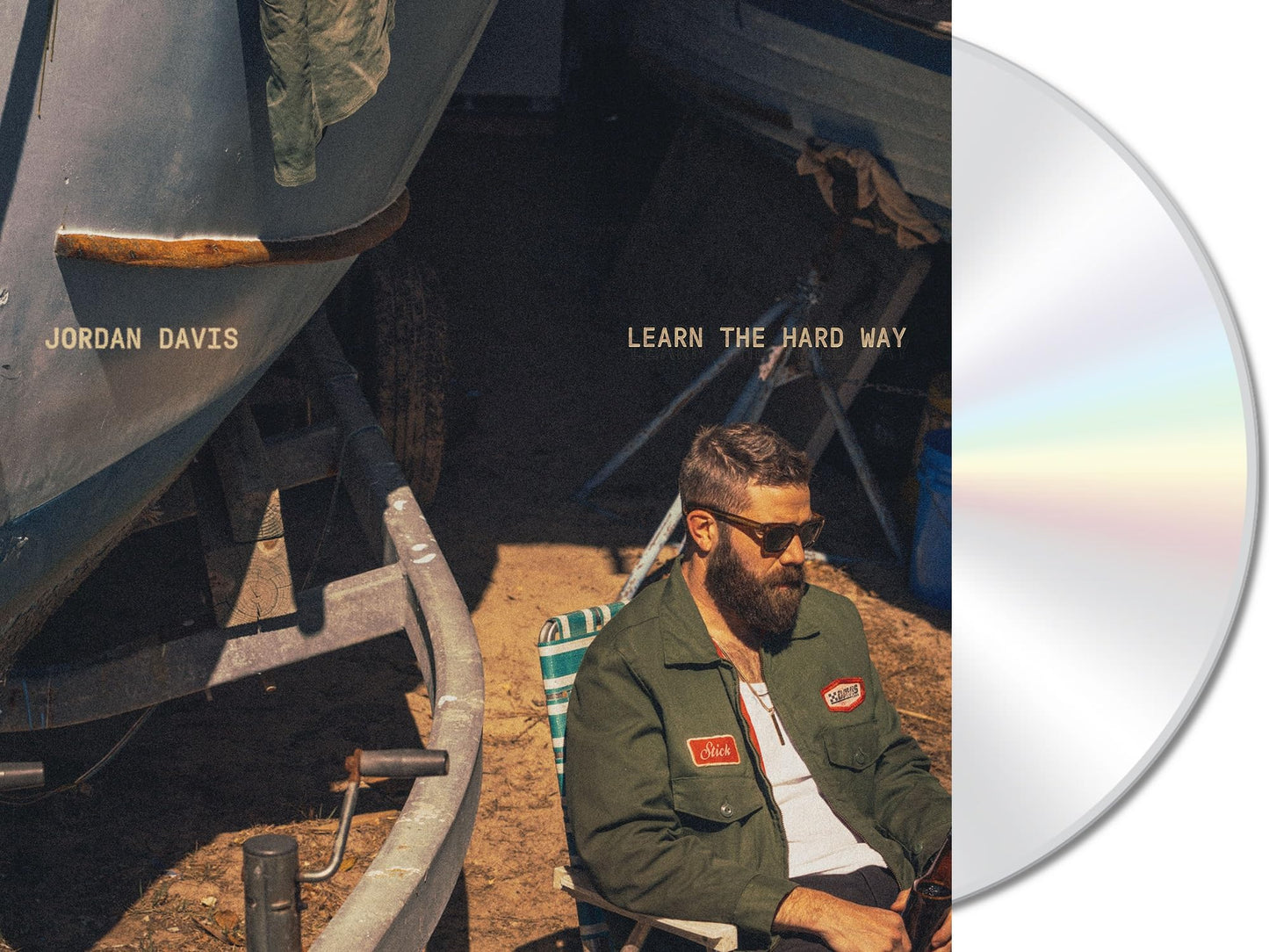 CD cover featuring Jordan Davis seated near a weathered boat.