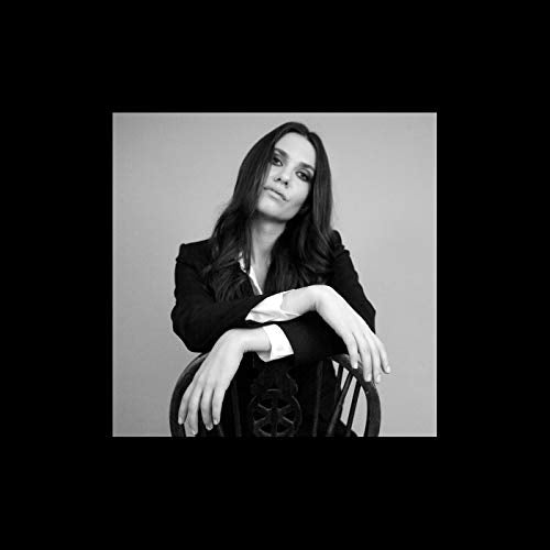 Black and white portrait of a woman seated in a chair.