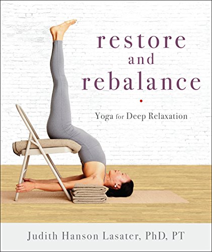 Woman in supported shoulderstand pose on a chair, yoga instruction.