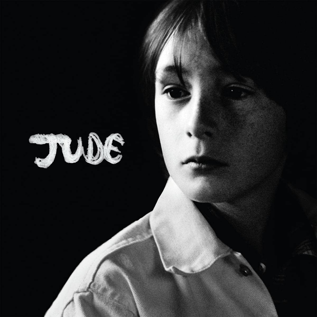 Black and white album cover featuring a young boy with the word "JUDE" written beside him.
