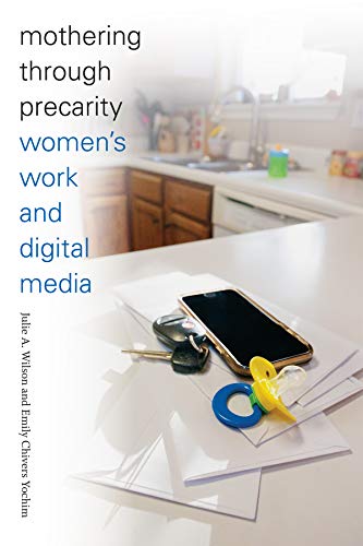 Book cover with phone, keys, pacifier, and blurred kitchen background.