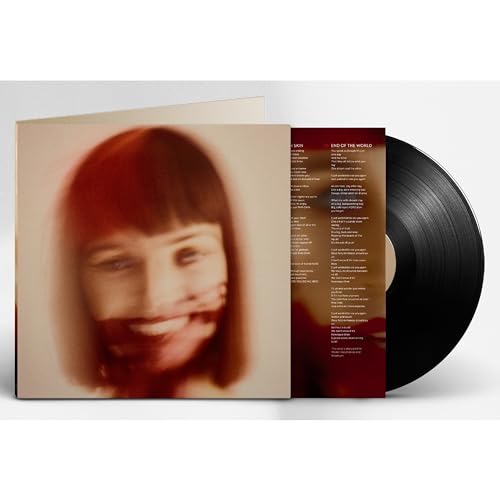 Vinyl record with album cover featuring a blurred portrait of a woman.