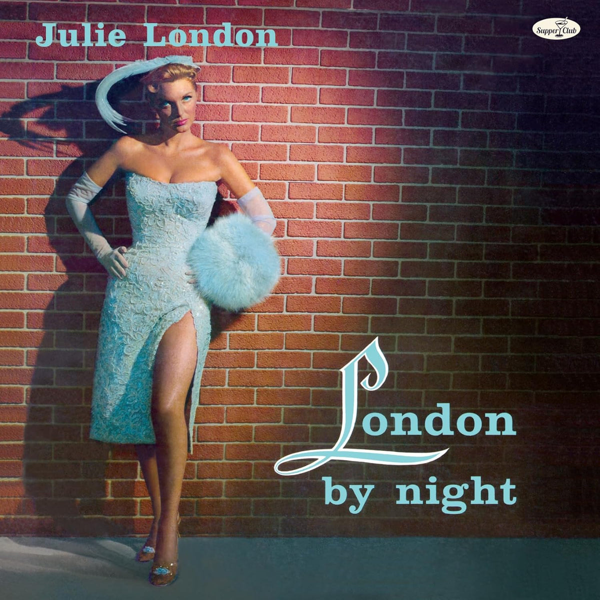 Julie London album cover: woman in blue dress against a brick wall.