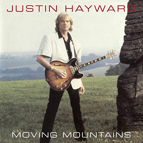 Justin Hayward holding a guitar in a field, album cover art.