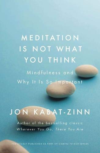 Book cover with blue background, white text, and three smooth stones.