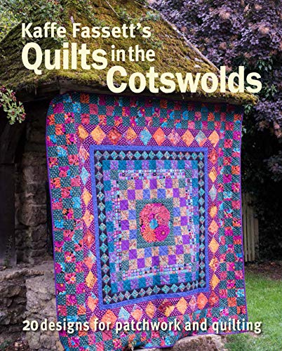 Book cover featuring a colorful patchwork quilt displayed on a stone wall.