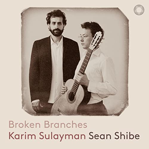 Two men with a guitar, sepia toned album cover for “Broken Branches.”