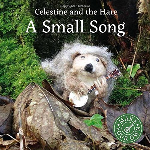 A felted hedgehog plays a small banjo in a mossy, leaf-covered forest setting.