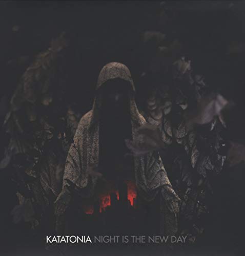 Hooded figure standing in darkness with glowing embers below, album cover.