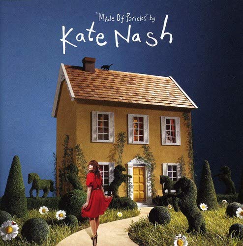 Kate Nash album cover: yellow house, garden, and woman in red dress.