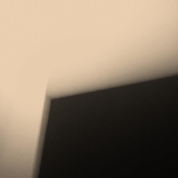 Dark rectangular object with a light-colored edge, abstract composition.