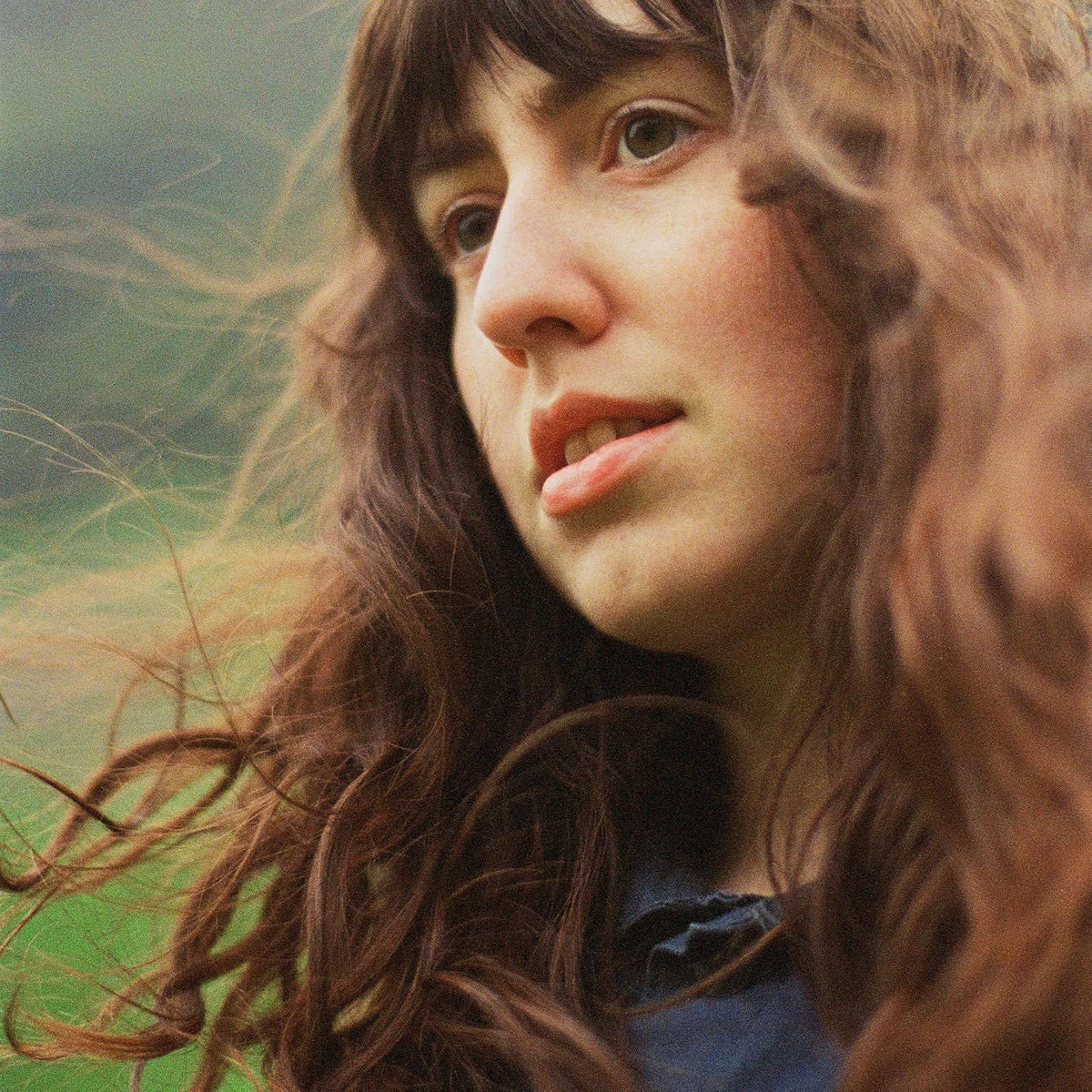 Close-up portrait of Katie Gregson-MacLeod with long, wavy brown hair.