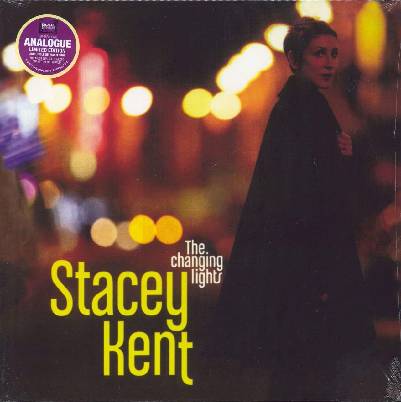 Stacey Kent album cover, woman seen from behind amidst blurred lights.