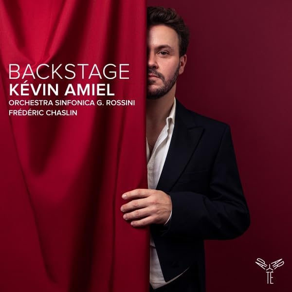 CD cover: Man in suit partially hidden behind red curtain.