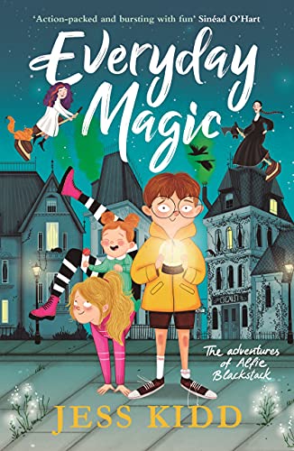 Book cover with children, a glowing orb, and a spooky town backdrop.