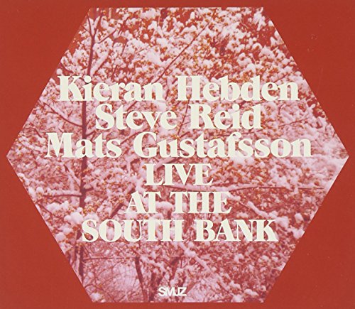 CD cover with hexagonal design, pink blossoms, and artist names.