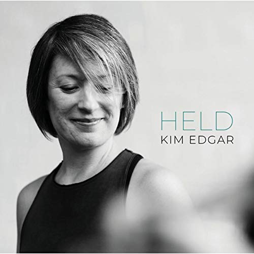 "Album cover with black and white portrait of a smiling woman."