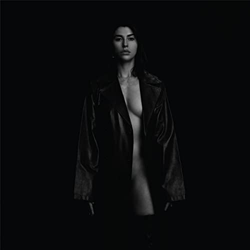 Black and white portrait of Kimbra in a leather jacket.