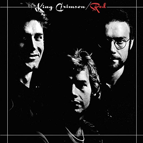 Black and white portrait of three men with the text King Crimson Red above.
