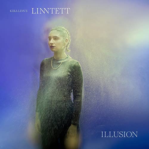 CD cover for Kira Linn’s “Illusion” featuring a woman with falling particles.