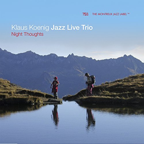 "Album cover featuring two hikers by a lake with mountains in the background."