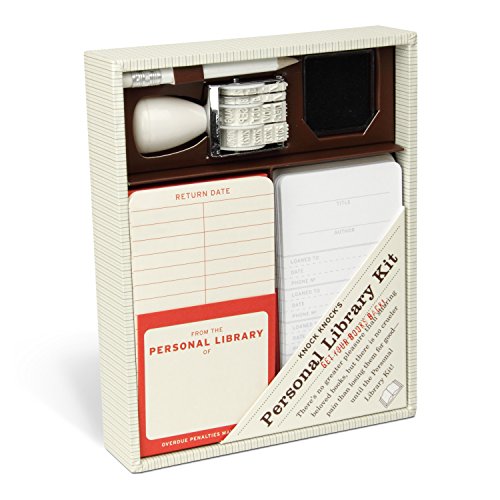 Open box displaying vintage-style library checkout cards, stamp, and inkpad.