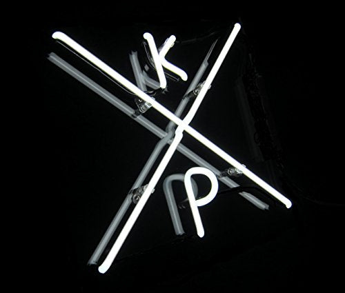 White neon sign spelling "Kxp" against a black background.