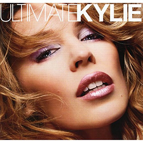 Close-up of Kylie Minogue with dramatic makeup, album cover art.