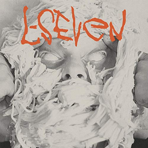 The alt text for the image is: "Vinyl album cover with a person's face covered in white substance."
