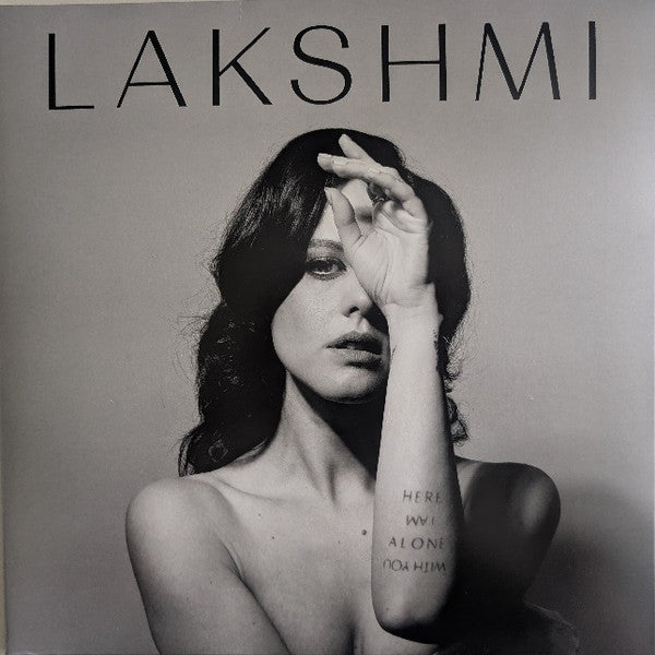 Black and white album cover featuring a woman partially obscuring her face.