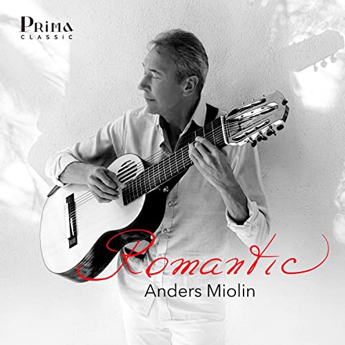 Black and white portrait of a man playing a classical guitar.