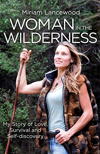 A woman in a fur vest holds a wooden staff in a forest setting.
