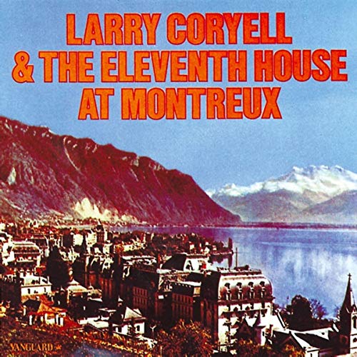Album cover featuring a lakeside town with mountains and red text on blue sky.