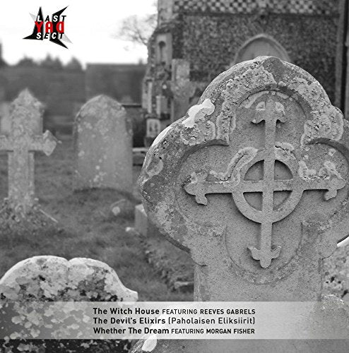 Black and white photo of a Celtic cross gravestone in a cemetery.