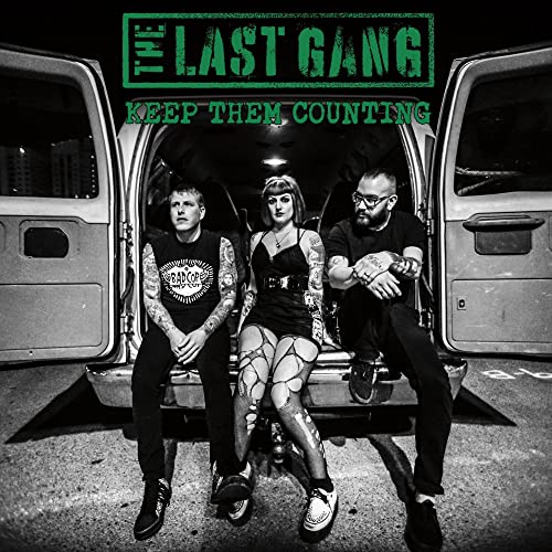 Black and white album cover featuring three people seated in a van.