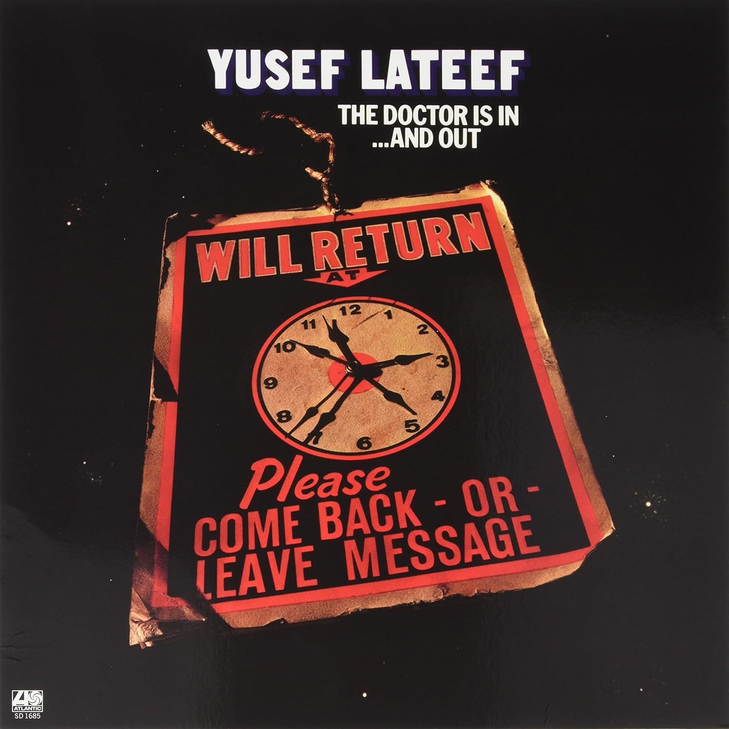 Vinyl record cover: clock face on a distressed, red sign with text.