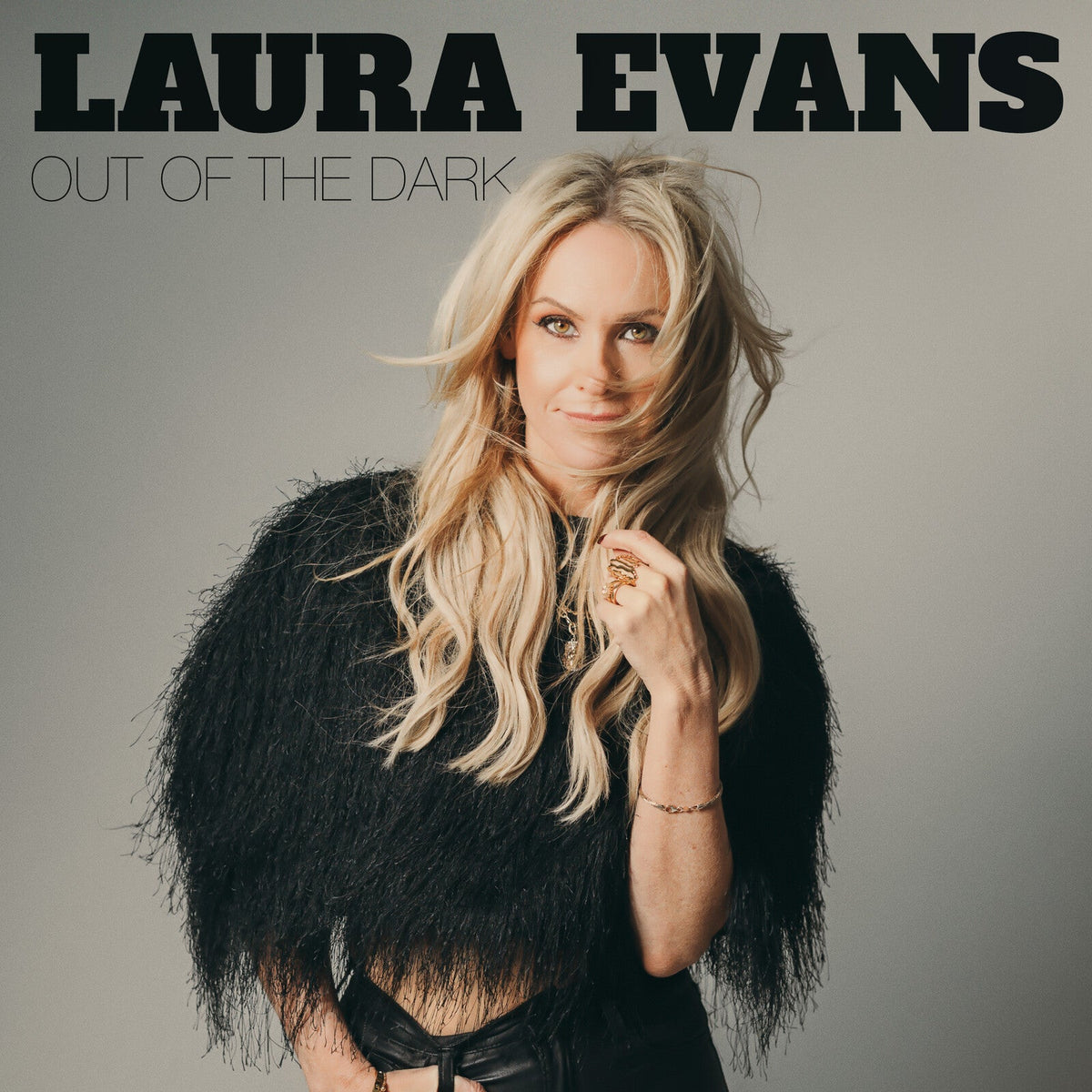 Laura Evans album cover, portrait of blonde woman in black feather wrap.