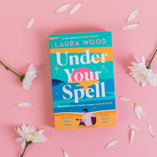Book cover for Under Your Spell by Laura Wood surrounded by white flower petals.