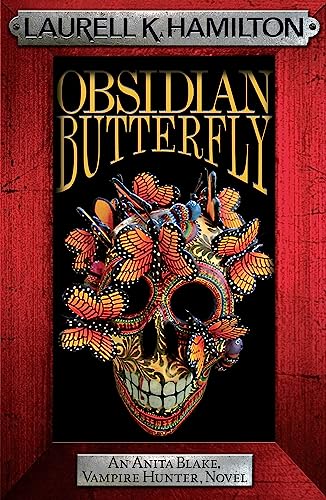 Book cover with skull decorated with colorful butterflies on a red wooden background.