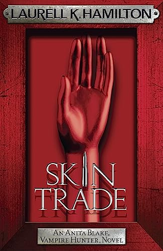 Book cover: red hand with a stake, title “Skin Trade” in silver.